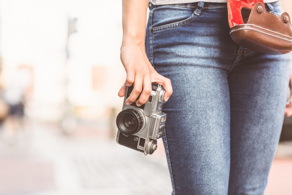 Woman in slim fit jeans with camera