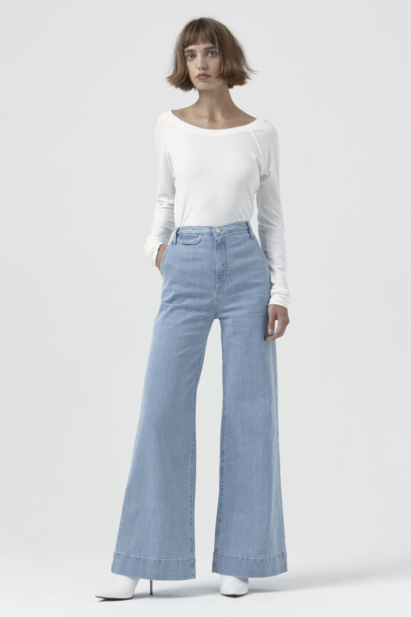 woman wearing katherine hamnett anita flared jeans with white top