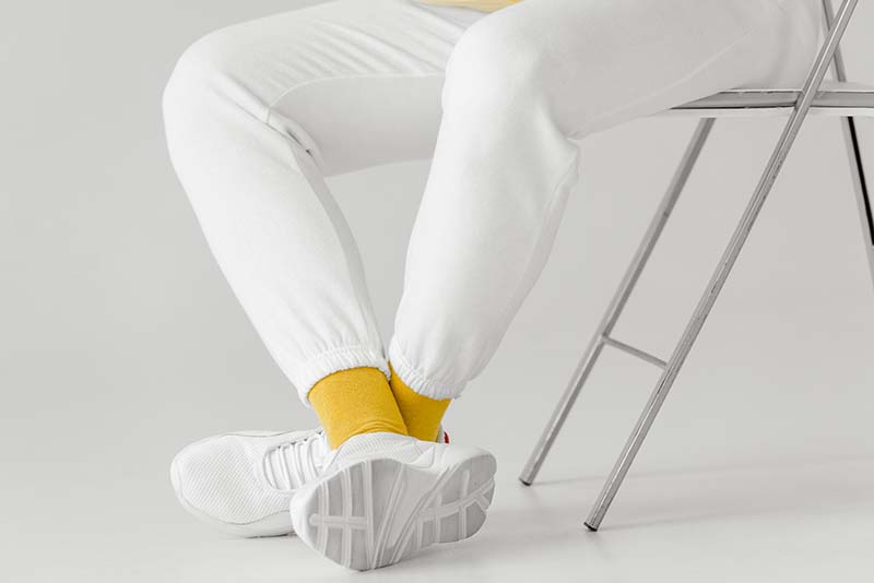 Yellow socks with white sneakers and white trousers