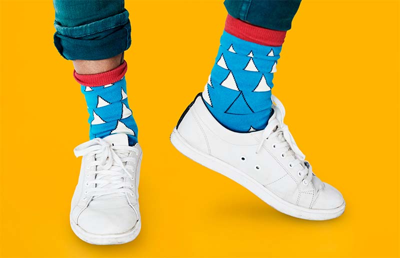Blue socks with triangle motif paired with white sneakers